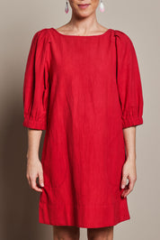 Model Katie wearing size 10 of the Puff Sleeve Cotton Dress in colour Ribbonred (Red), from the front, cropped image