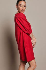 Model Katie wearing size 10 of the Puff Sleeve Cotton Dress in colour Ribbonred (Red), from the front, cropped image