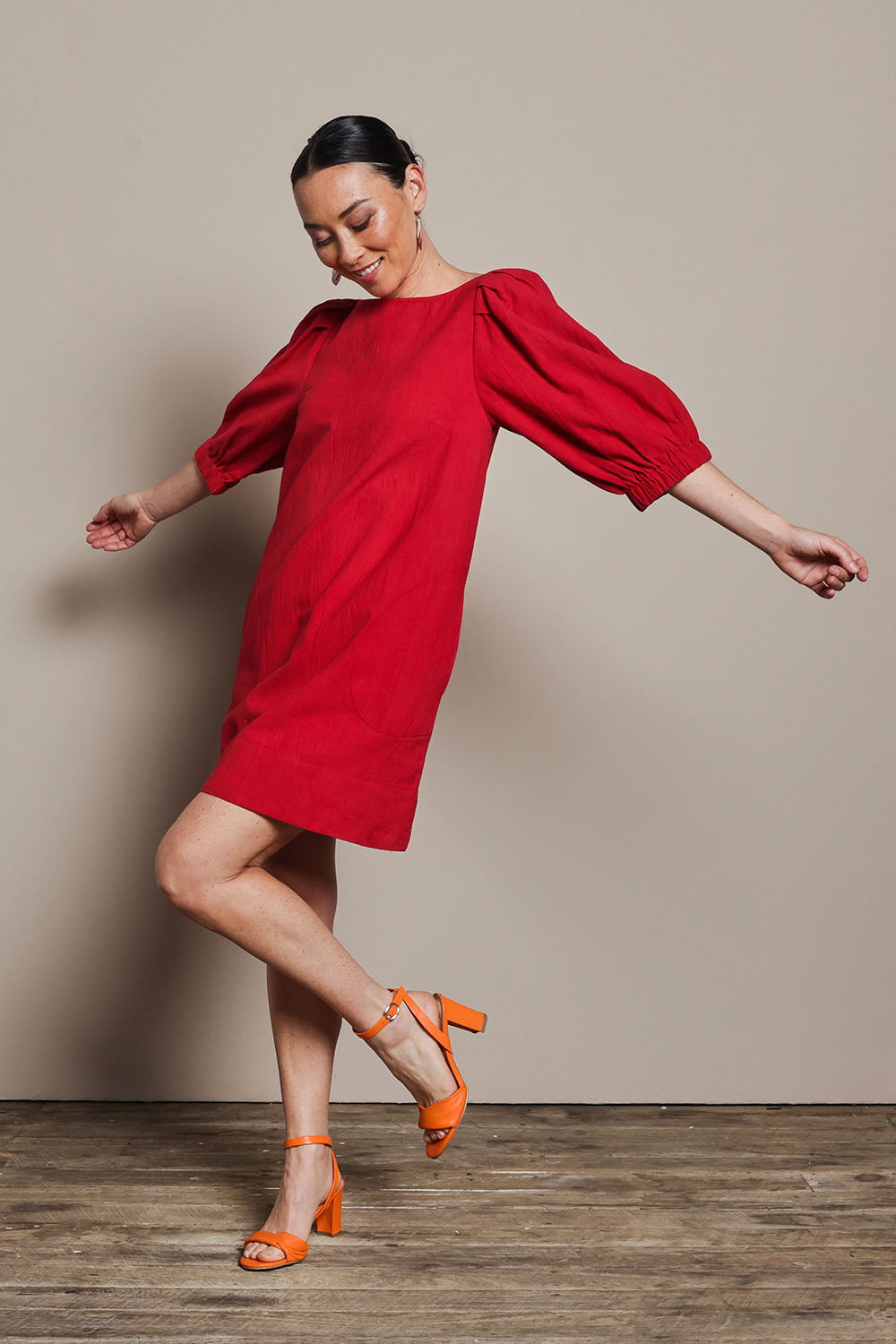 Model Katie wearing size 10 of the Puff Sleeve Cotton Dress in colour Ribbonred (Red), from the front, showing the whole outfit