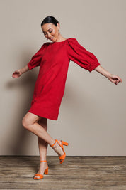 Model Katie wearing size 10 of the Puff Sleeve Cotton Dress in colour Ribbonred (Red), from the front, showing the whole outfit