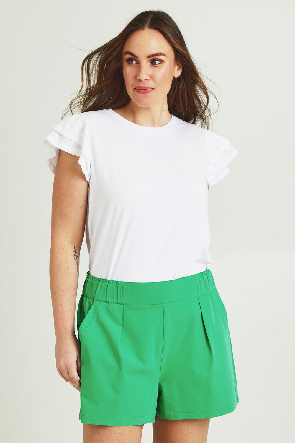 Model Jane wearing size 14 of the Pull On Shorts in colour Applegrn (Green), from the front, cropped image