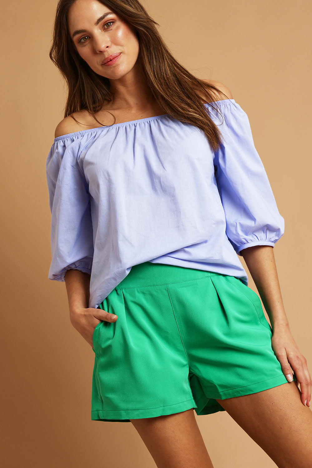 Model Madeline wearing size 10 of the Pull On Shorts in colour Applegrn (Green), from the front, showing the whole outfit