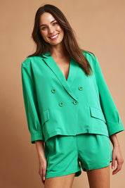 Model Madeline wearing size 10 of the Double Breasted Blazer in colour Applegrn (Green), from the front, showing the whole outfit