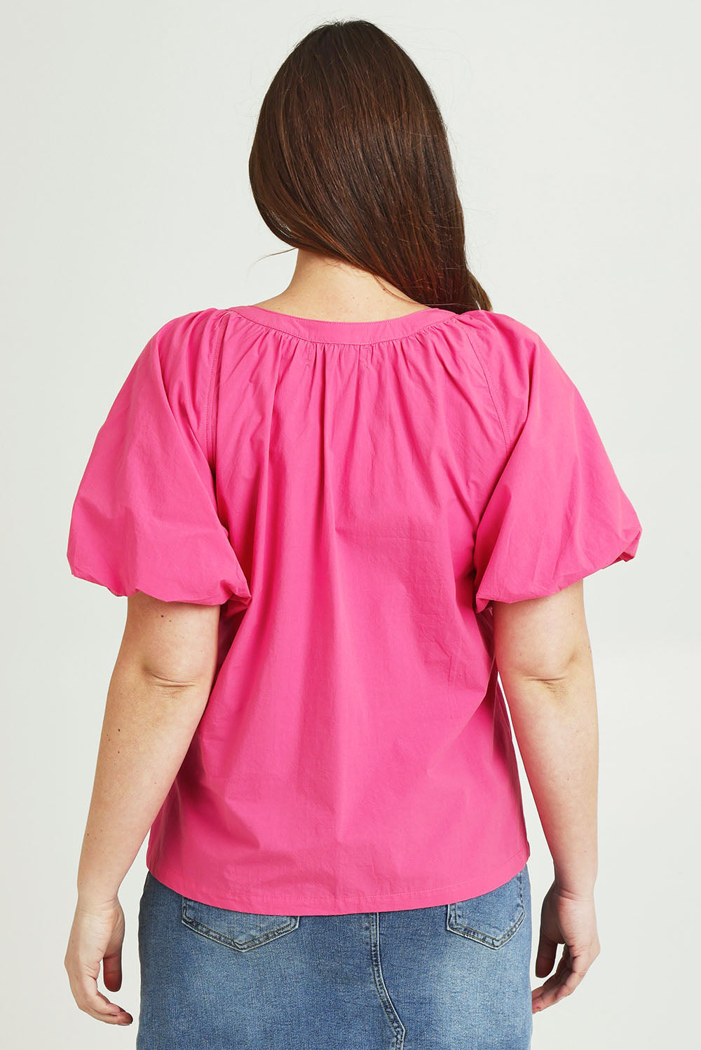 Model Jane wearing size 14 of the Puff Sleeve Cotton Shirt in colour Carnation (Pink), from the back