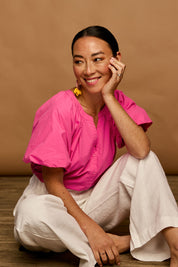 Model Katie wearing size 10 of the Puff Sleeve Cotton Shirt in colour Carnation (Pink), from the front, showing the whole outfit