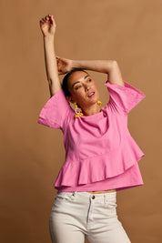 Model Katie wearing size 10 of the Asymmetrical Frill Cotton Top in colour Pink (Pink), from the front, showing the whole outfit