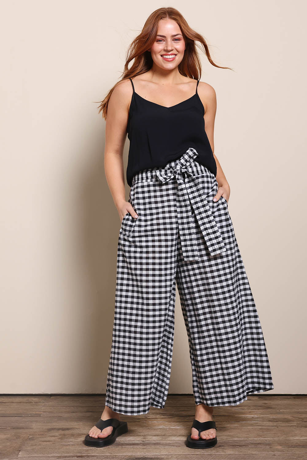 Model Georgiel wearing size 10 of the Cotton Waist Tie Pants – Gingham in colour Gingham, from the front