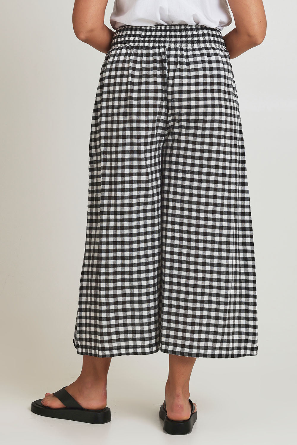 Model Terri-Leigh wearing size 14 of the Cotton Waist Tie Pants in colour Gingham (Black), from the back