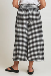 Model Terri-Leigh wearing size 14 of the Cotton Waist Tie Pants in colour Gingham (Black), from the back