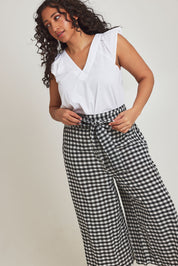 Model Terri-Leigh wearing size 14 of the Cotton Waist Tie Pants in colour Gingham (Black), from the front, cropped image