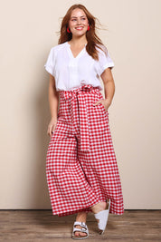 Model Georgiel wearing size 10 of the Cotton Waist Tie Pants – Ginghamred in colour Ginghamred, from the front