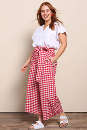Model Georgiel wearing size 10 of the Cotton Waist Tie Pants – Ginghamred in colour Ginghamred, from the front