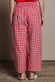 Model Katie wearing size 10 of the Cotton Waist Tie Pants in colour Ginghamred (Red), from the back