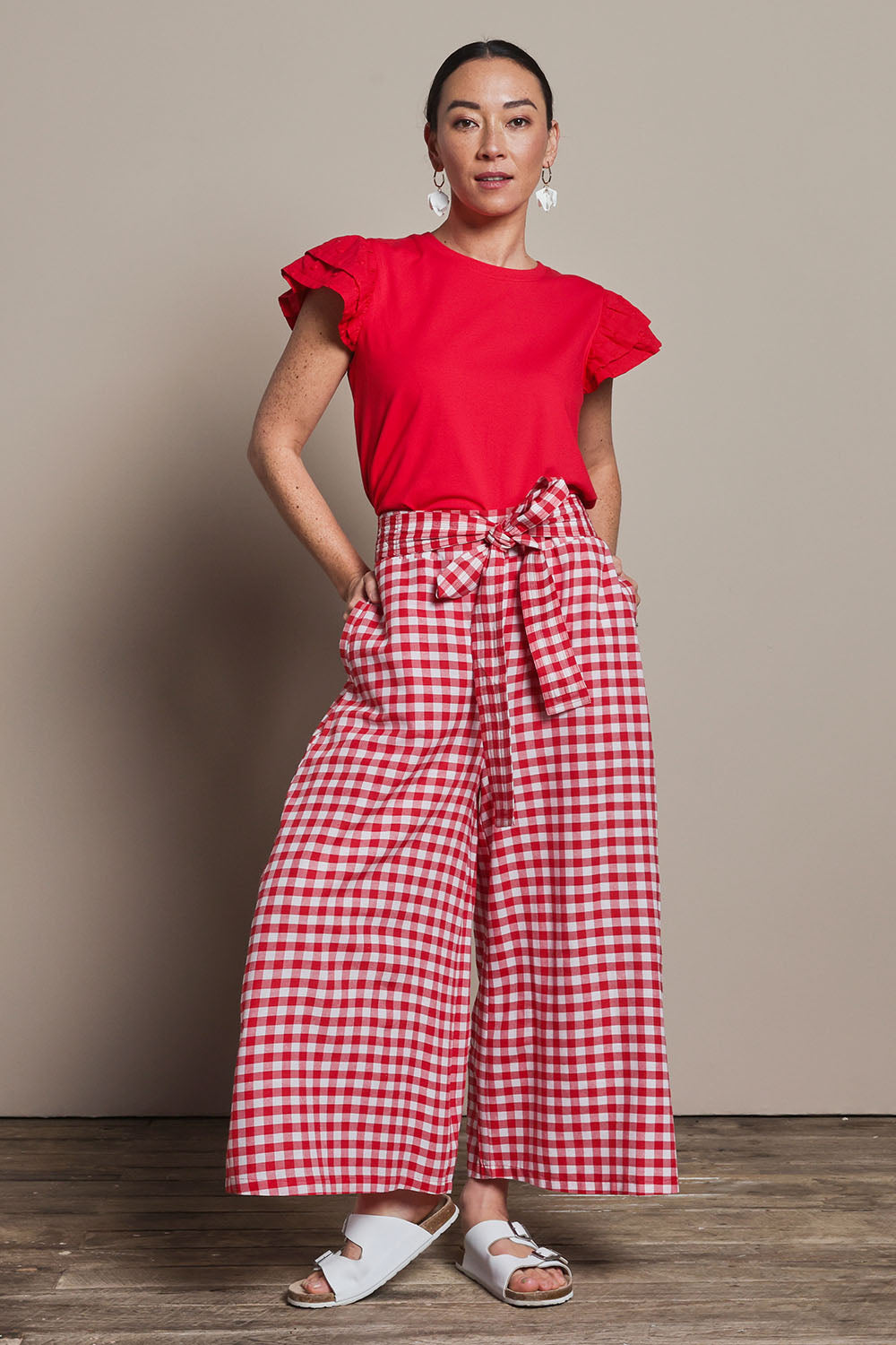 Model Katie wearing size 10 of the Cotton Waist Tie Pants in colour Ginghamred (Red), from the front, showing the whole outfit