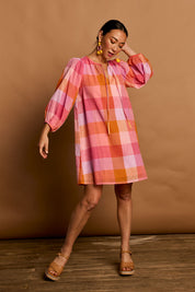Model Katie wearing size 10 of the Yarn Dyed Cotton Sundress in colour Sherbet (Pink), from the front, showing the whole outfit