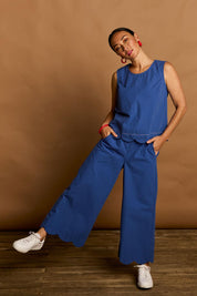 Model Katie wearing size 10 of the Scalloped Hem Cotton Tank in colour Palaceblue (Blue), from the front, showing the whole outfit