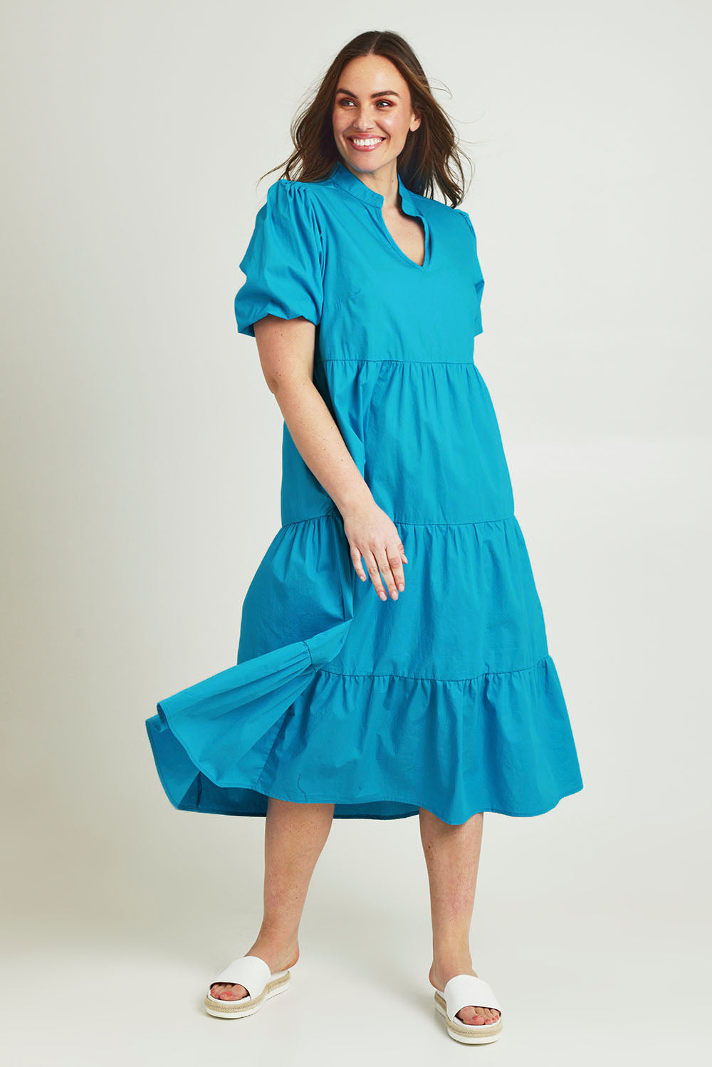 Model Jane wearing size 14 of the Tiered Cotton Dress in colour Jewel (Blue), from the front, showing the whole outfit