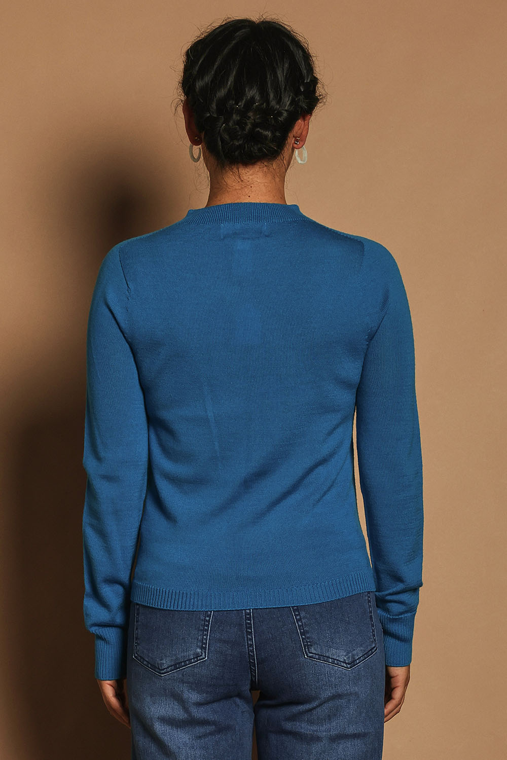 Model Katie wearing size S of the Extra Fine Merino Wool Long Sleeve Knit in colour Blue (Blue), from the back