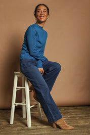 Model Katie wearing size S of the Extra Fine Merino Wool Long Sleeve Knit in colour Blue (Blue), from the front, showing the whole outfit