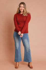Model Chanel wearing size XL of the Extra Fine Merino Wool Long Sleeve Knit in colour Rust, from the front, showing the whole outfit