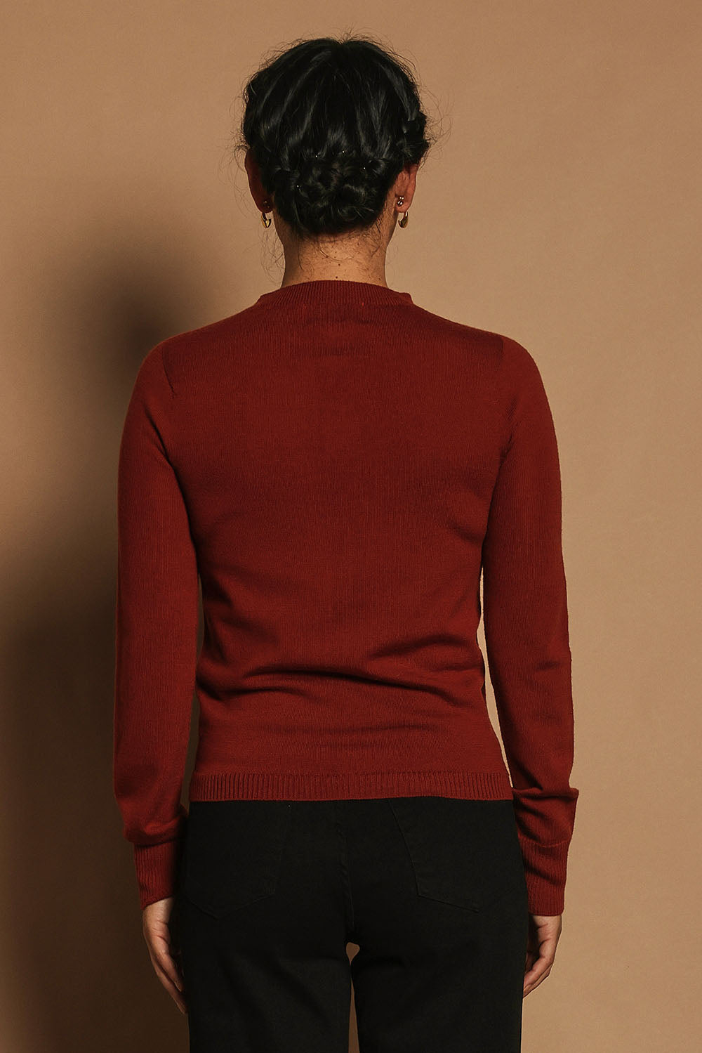 Model Katie wearing size S of the Extra Fine Merino Wool Long Sleeve Knit in colour Rust, from the back