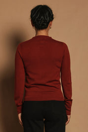 Model Katie wearing size S of the Extra Fine Merino Wool Long Sleeve Knit in colour Rust, from the back