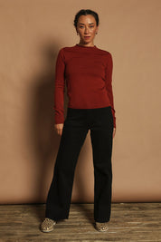 Model Katie wearing size S of the Extra Fine Merino Wool Long Sleeve Knit in colour Rust, from the front, showing the whole outfit