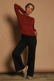 Model Katie wearing size S of the Extra Fine Merino Wool Long Sleeve Knit in colour Rust, from the front, showing the whole outfit