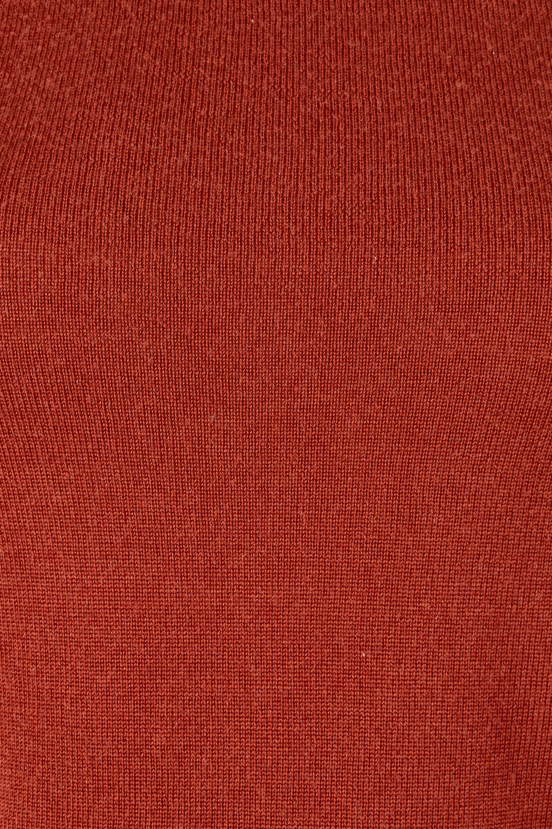 Product shot of the Extra Fine Merino Wool Long Sleeve Knit in colour Rust, detail