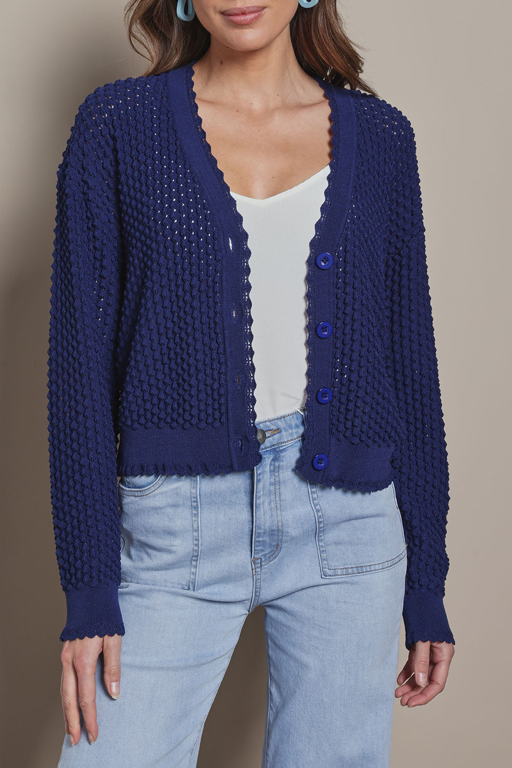 Model Madeline wearing size S of the Waffle Textured Cardigan in colour Navy (Blue), from the front, cropped image