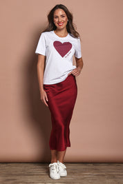 Model Madeline wearing size 10 of the Mercerized Cotton Love Tee in colour Burgundy (Red), from the front, showing the whole outfit