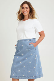 Model Chanel wearing size 16 of the Daisy Denim A Line Skirt in colour Daisy (Blue), from the front, cropped image