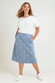 Model Chanel wearing size 16 of the Daisy Denim A Line Skirt in colour Daisy (Blue), from the front, showing the whole outfit