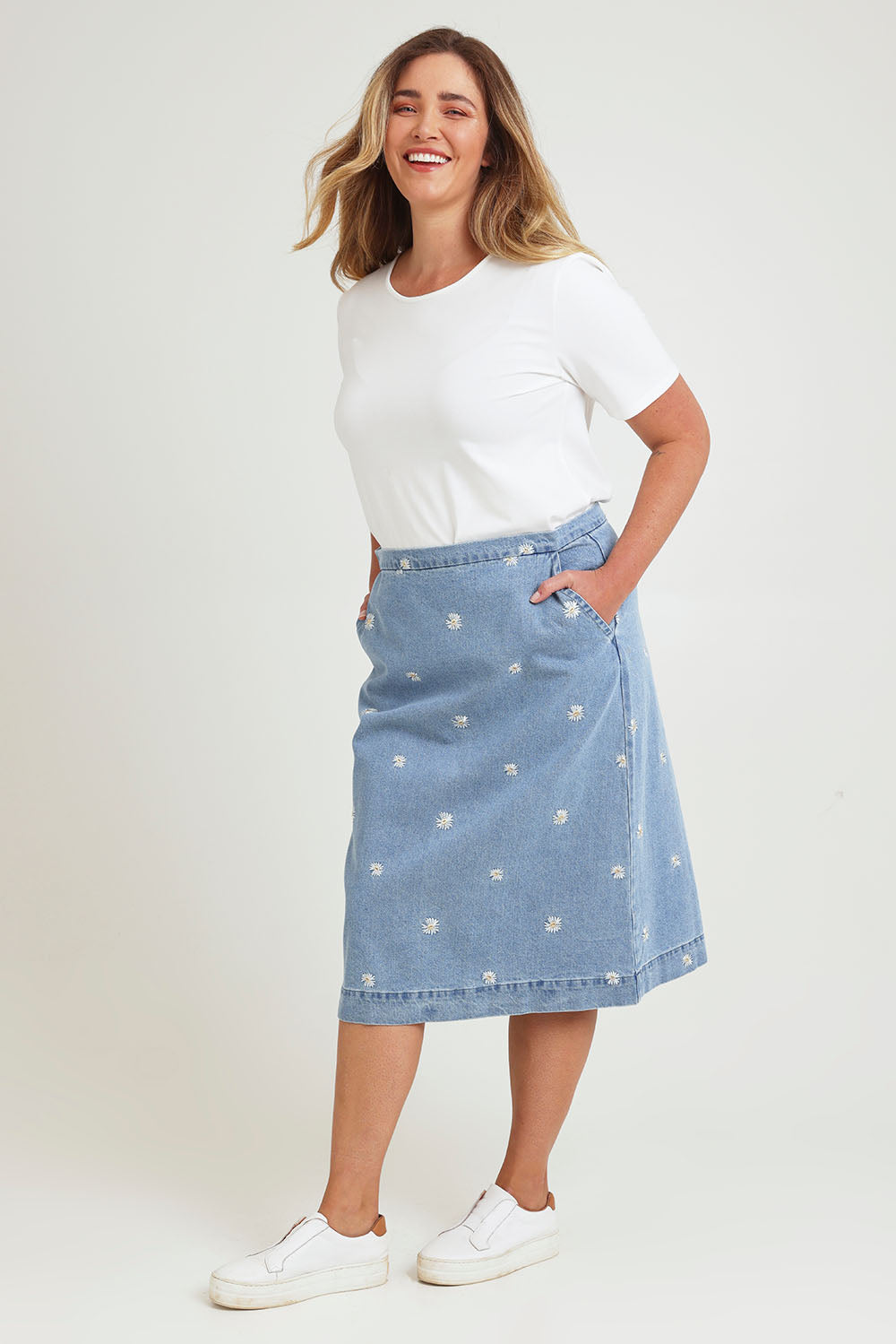 Model Chanel wearing size 16 of the Daisy Denim A Line Skirt in colour Daisy (Blue), from the front, showing the whole outfit