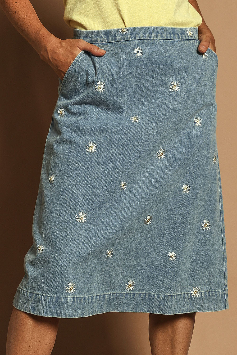 Model Katie wearing size 10 of the Daisy Denim A Line Skirt in colour Daisy (Blue), from the front, cropped image