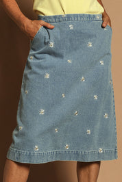 Model Katie wearing size 10 of the Daisy Denim A Line Skirt in colour Daisy (Blue), from the front, cropped image