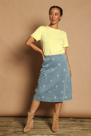 Model Katie wearing size 10 of the Daisy Denim A Line Skirt in colour Daisy (Blue), from the front, showing the whole outfit