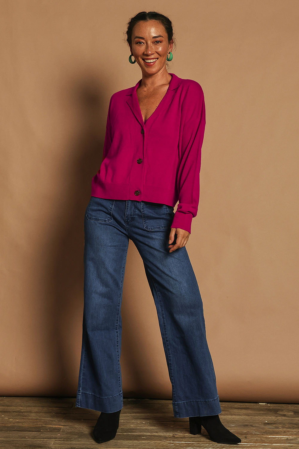 Model Katie wearing size S of the Relaxed Collar Cardigan in colour Fuschia (Pink), from the front, showing the whole outfit