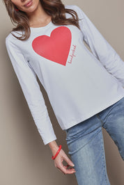 Model Madeline wearing size 10 of the Mercerized Cotton Love Long Sleeve Tee in colour Red (White), from the front, cropped image