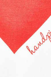 Product shot of the Mercerized Cotton Love Long Sleeve Tee in colour Red (White), detail