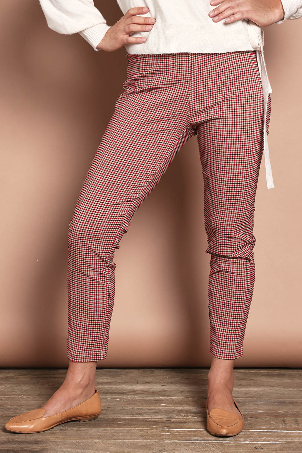 Model Katie wearing size 10 of the Pull On Check Pants in colour Redcheck (Red), from the front, cropped image