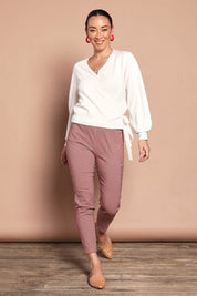 Model Katie wearing size 10 of the Pull On Check Pants in colour Redcheck (Red), from the front, showing the whole outfit