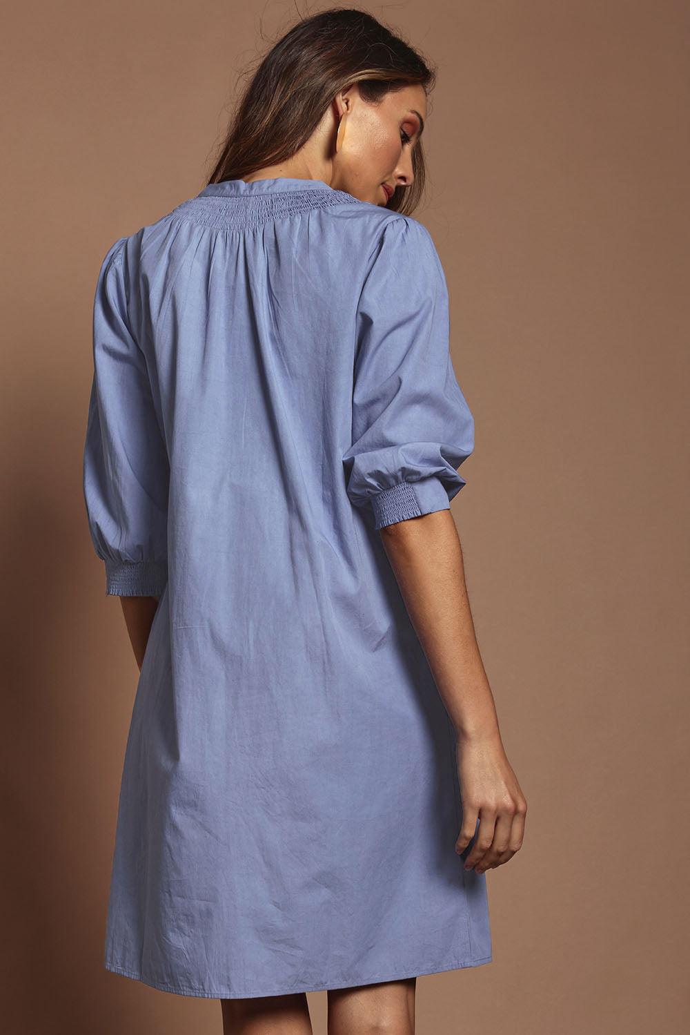 Model Madeline wearing size 10 of the Cotton Button Up Dress in colour Wisteria (Purple), from the back