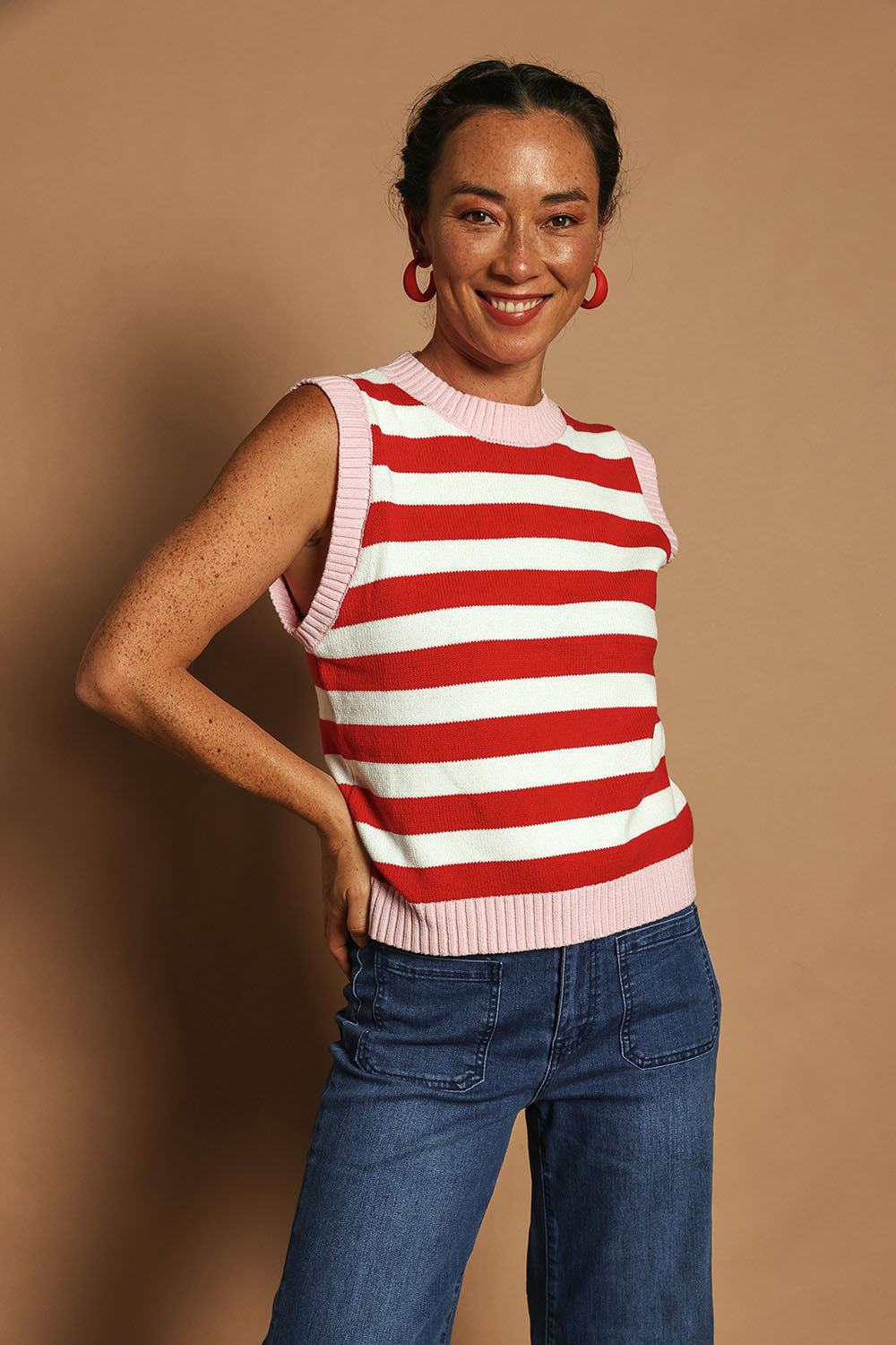 Model Katie wearing size S of the Cotton Blend Stripe Vest in colour Redwhite (Red), from the front, showing the whole outfit