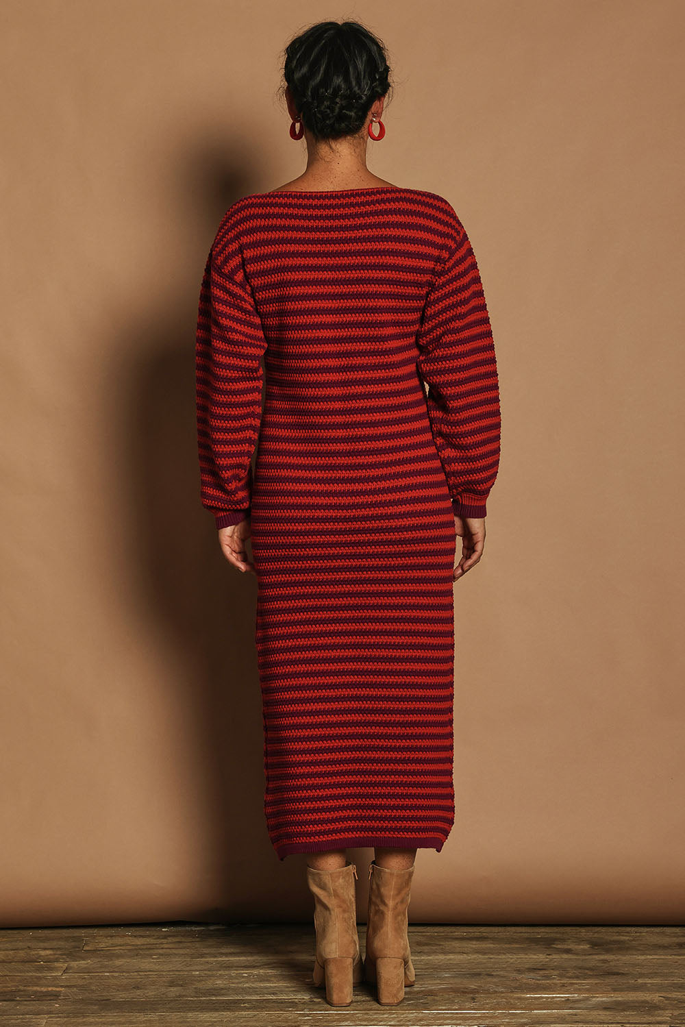 Model Katie wearing size S of the Cotton Stripe Knit Dress in colour Redpurple (Red), from the back