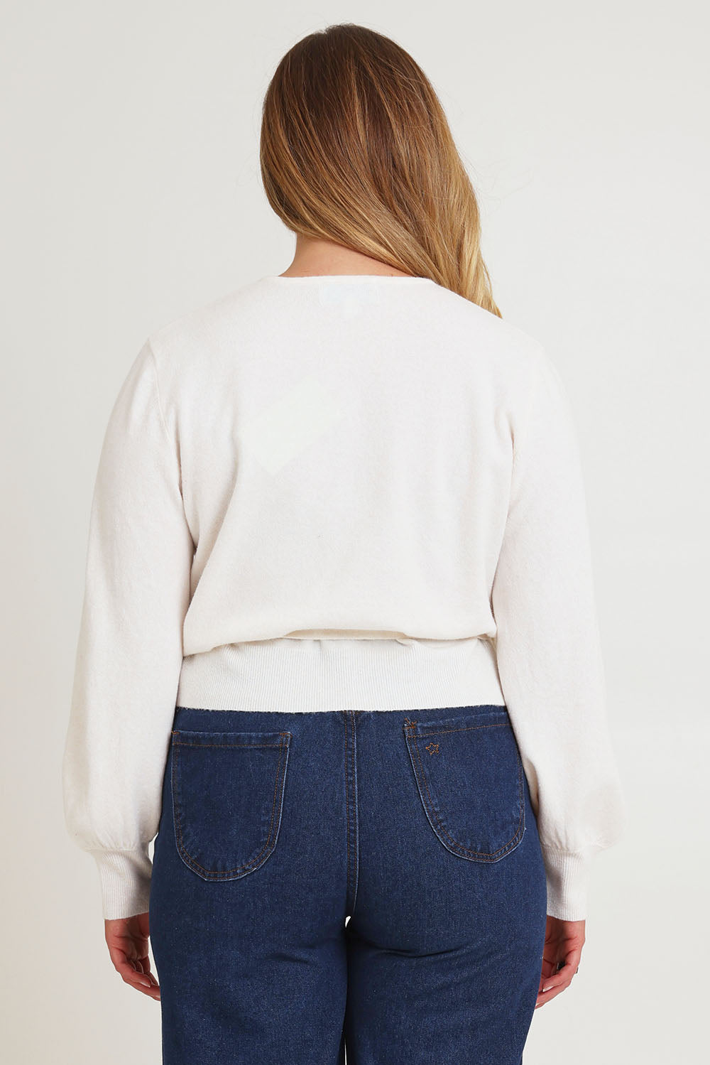 Model Chanel wearing size XL of the Wrap Knit Sweater in colour Cream (White), from the back