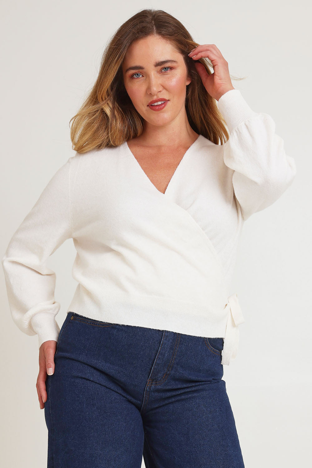 Model Chanel wearing size XL of the Wrap Knit Sweater in colour Cream (White), from the front, cropped image