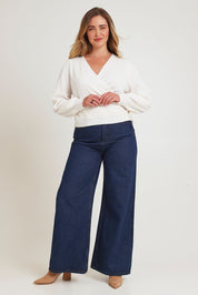 Model Chanel wearing size XL of the Wrap Knit Sweater in colour Cream (White), from the front, showing the whole outfit