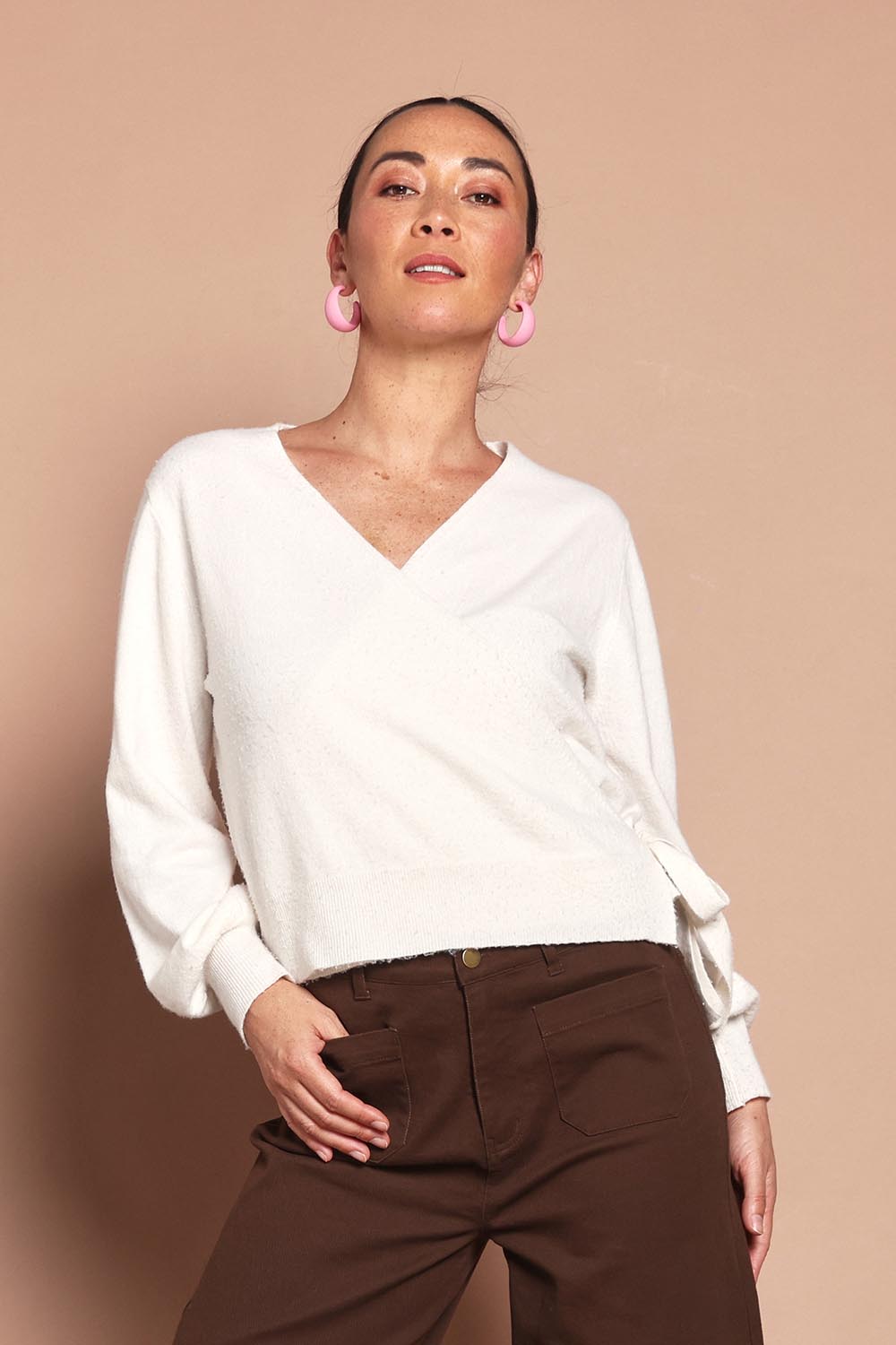 Model Katie wearing size S of the Wrap Knit Sweater in colour Cream (White), from the front, cropped image