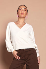Model Katie wearing size S of the Wrap Knit Sweater in colour Cream (White), from the front, cropped image